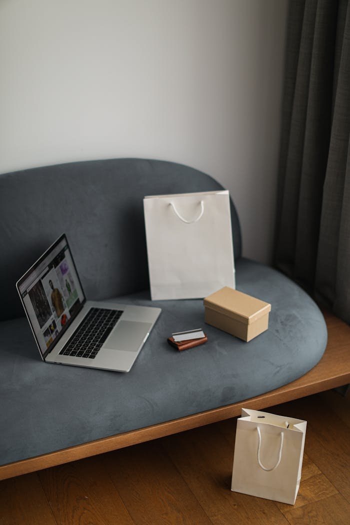 Contemporary e-commerce scene with laptop, shopping bags, and a credit card, ideal for online shopping concepts.